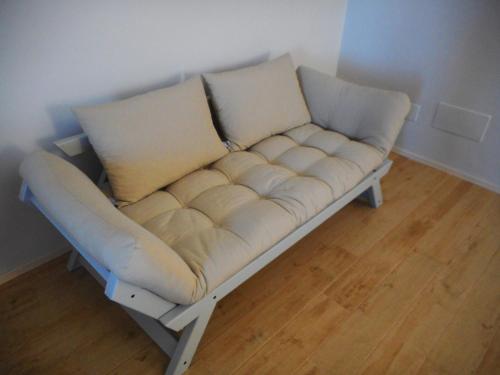 a couch with two pillows on it in a room at Anaka sweet home in Agrigento