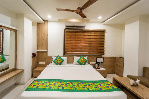 a bedroom with a large bed and a couch at Treebo Ashirwad Regency in Bhopal