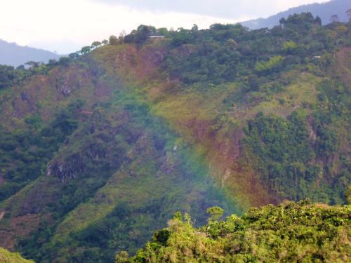 a rainbow on the side of a mountain at Finca El Cielo in San Agustín