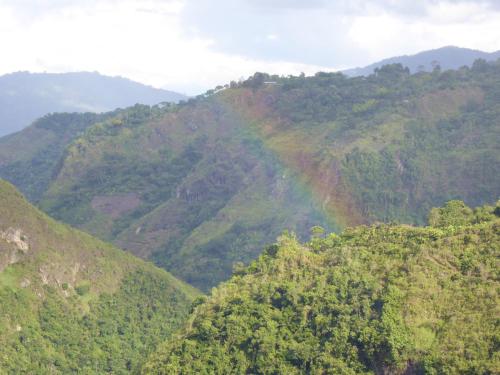 a rainbow on the side of a mountain at Finca El Cielo in San Agustín