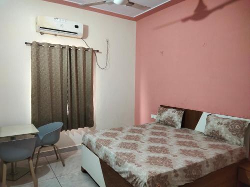 a bedroom with a bed and a heater on the wall at Agora Hotel in Muzaffarnagar