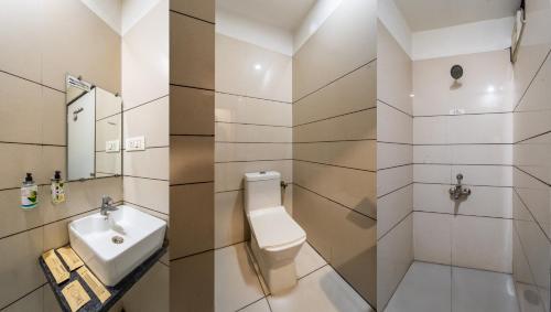 a bathroom with a toilet and a sink at Treebo Ashirwad Regency in Bhopal