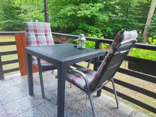 a black table and two chairs on a patio at The Hideaway in Želiv