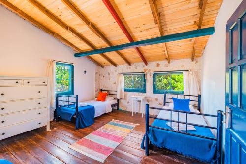 a bedroom with two bunk beds and a crib at Amara Nature Homes in Kaş
