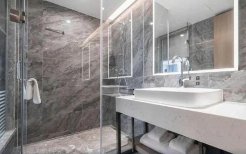 a bathroom with a sink and a shower at Nanning Prince Hotel in Nanning