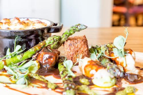 a plate of food with vegetables on a table at The White Hart Hotel in Welwyn