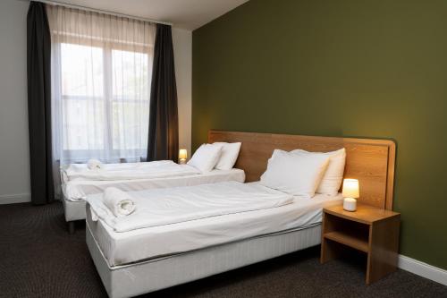 Ένα ή περισσότερα κρεβάτια σε δωμάτιο στο Hotel Mátrix