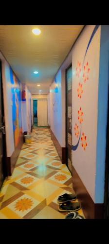 a hallway with a tile floor in a building at The Rainbow Residency guest house in Varanasi