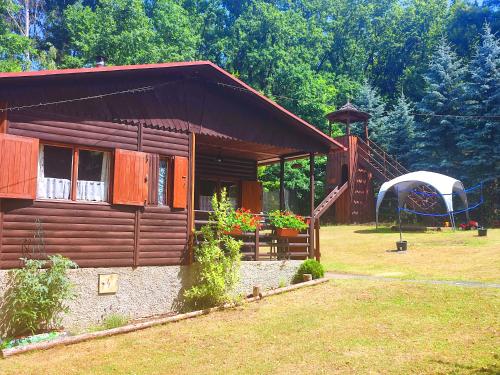 a log cabin with a gazebo in a yard at The Hideaway in Želiv
