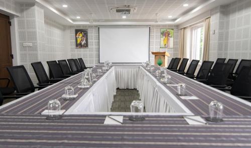 a meeting room with a long table and chairs at Bhutan Peaceful Residency and Spa in Thimphu