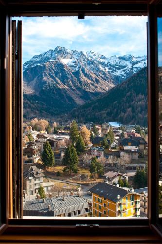 a view from a window of a town with mountains at Hotel Garnì Cristallo in Ponte di Legno