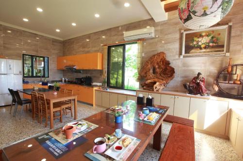 a kitchen with a table and a dining room at Yiho B&B in Ji'an