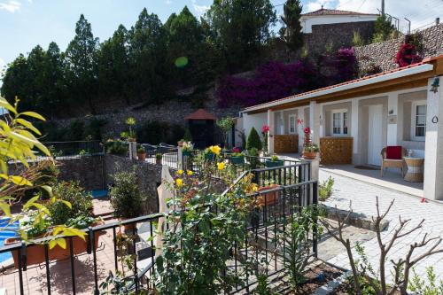 a garden with flowers and a fence at Casa de São Domingos in Peso da Régua