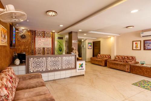 a lobby with couches and chairs in a store at Treebo Red Coral in Haridwār