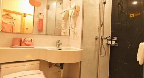 a bathroom with a sink and a toilet and a shower at Cozy Hotel Xiamen in Xiamen