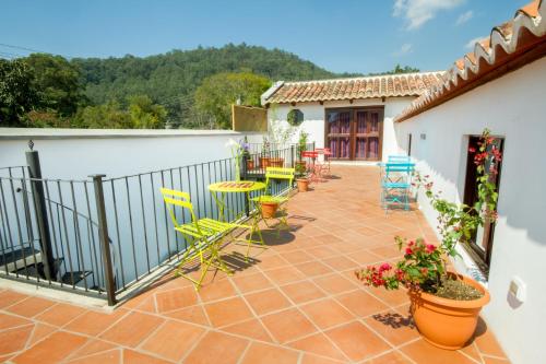 a patio with chairs and tables and a fence at Casa Elena in Antigua Guatemala