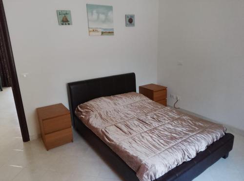a bedroom with a bed and two night stands at Sunshine calabria in Pizzo