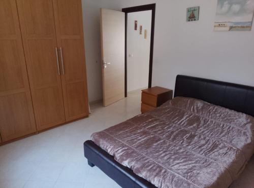 a bedroom with a bed and a wooden cabinet at Sunshine calabria in Pizzo