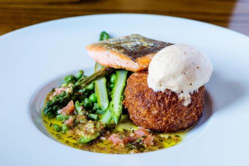 a plate of food with meat and vegetables on a table at The White Hart Hotel in Welwyn
