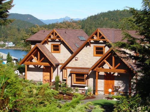 a log home with a gambrel roof at Sunshine Coast Resort in Madeira Park