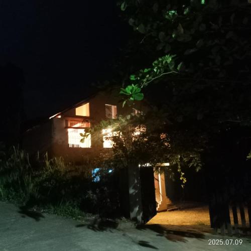 a house at night with a tree in front of it at Kit Cott Resort and Retreat in Teligama