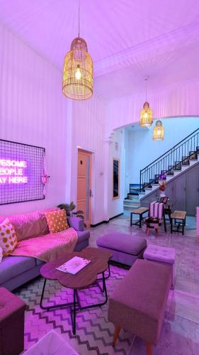 a living room with purple furniture and purple lighting at Casa de Vie Homestay in Malang