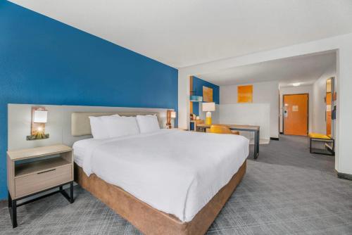 a bedroom with a large bed and a blue wall at Comfort Inn & Suites Sheboygan I-43 in Sheboygan