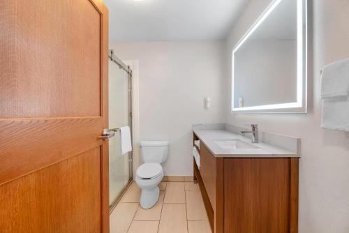 a bathroom with a toilet and a sink and a mirror at Comfort Inn & Suites Sheboygan I-43 in Sheboygan