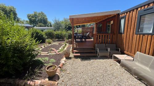 Ce chalet en bois dispose d'une terrasse couverte. dans l'établissement Mobilhome tout confort, à La Teste-de-Buch