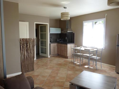 a kitchen with a table and chairs in a room at Studio Bel Air in Pimbo