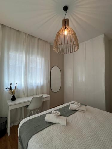 a bedroom with a bed with two towels on it at KK Athens Fine Stay-Steps to Metro-Modern & Cozy Apartments in Athens