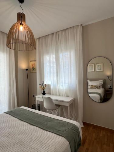 a bedroom with a bed and a desk and a mirror at KK Athens Fine Stay-Steps to Metro-Modern & Cozy Apartments in Athens