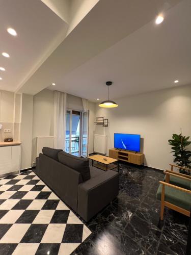 a living room with a couch and a tv at KK Athens Fine Stay-Steps to Metro-Modern & Cozy Apartments in Athens