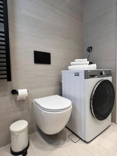 a bathroom with a toilet and a washing machine at KK Athens Fine Stay-Steps to Metro-Modern & Cozy Apartments in Athens
