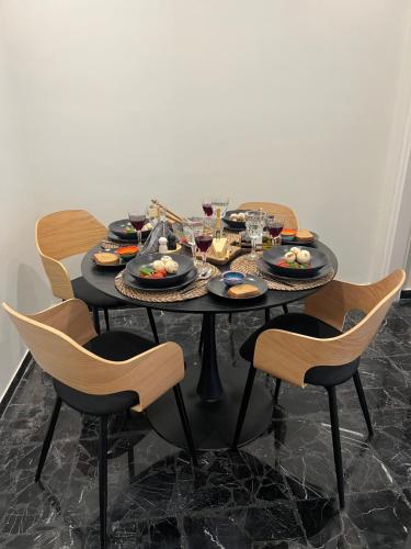a black table with plates of food on it at KK Athens Fine Stay-Steps to Metro-Modern & Cozy Apartments in Athens