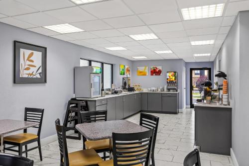 a restaurant with tables and chairs and a kitchen at Quality Inn Oak Grove Fort Campbell in Oak Grove