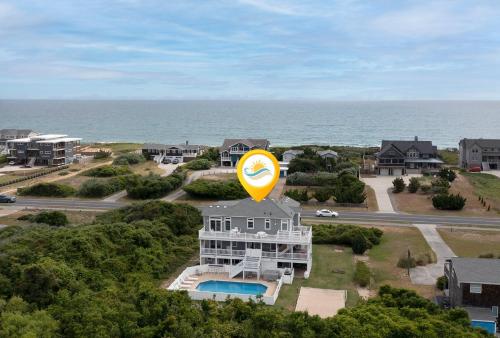 an aerial view of a house with a large yellow balloon at 3054 - Latitude Adjustment in Southern Shores