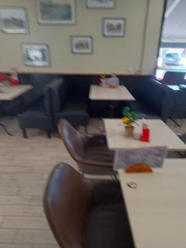 a waiting room with two tables and a chair at Hôtel des 2 Garess in Nevers