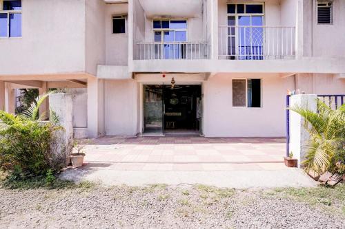 an apartment building with a door and a courtyard at SPOT ON Jahanvi Guest House in Neral