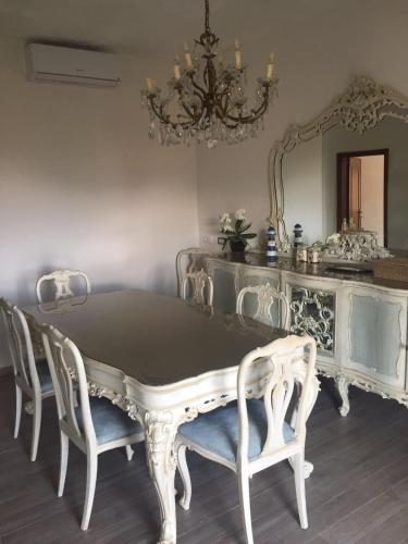 a dining room with a table and chairs and a mirror at B.E.A. Maison in La Spezia
