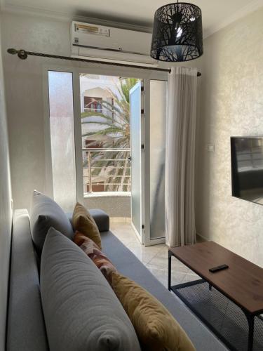 a living room with a couch and a table at City Center Blue Pearl in Al Hoceïma