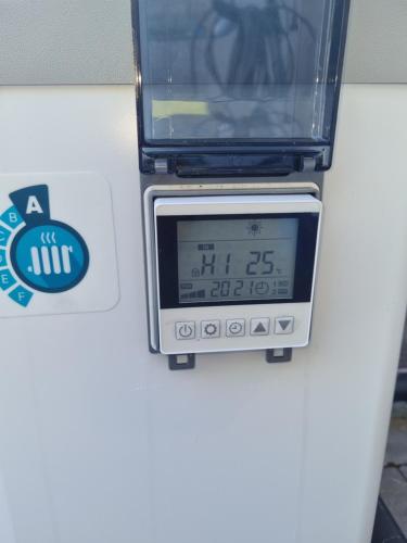 a toaster oven with a clock on top of it at Vikendica Artos in Bihać