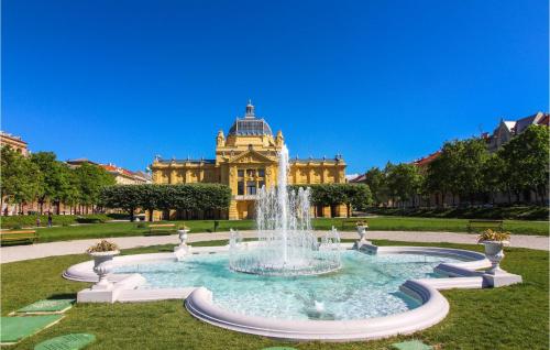 a fountain in front of a large building at Nice Home In Brezane Lekenicke in Brežane Lekeničke