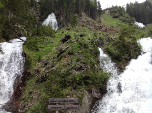 a view of a waterfall with a sign in front of it at Berghaus Außergschlöß in Matrei in Osttirol