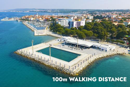 an aerial view of a dock with a pool in the water at Ilirija Resort Hotel Kornati in Biograd na Moru