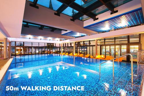 a large swimming pool in a building at Ilirija Resort Hotel Kornati in Biograd na Moru