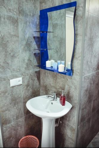 a bathroom with a sink and a mirror at Квари in Kvariat'i