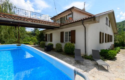 a villa with a swimming pool in front of a house at Casa Glicine in Pian di Mulino