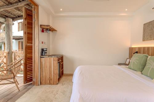 a bedroom with a white bed and a wooden cabinet at Islawa Soy Local - Isla Privada in Baru
