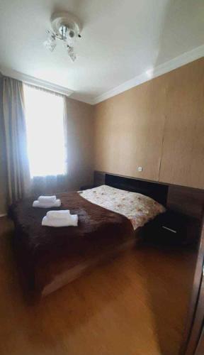 a bedroom with a bed with two towels on it at Guesthuse sadgeri in Tba